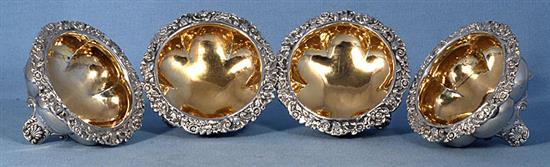 A set of four George III provincial silver table salts with matching mustard, Diameter 3 ¾”/94mm combined weight 21.5oz/609grm